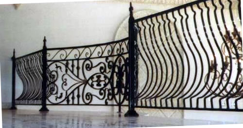 forged iron railing curving around a balcony